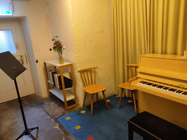Musizieren ist nur im Musikkammerl erlaubt, um seine Zimmernachbar:innen nicht zu stören. Dort stehen ein Notenständer und ein Klavier.